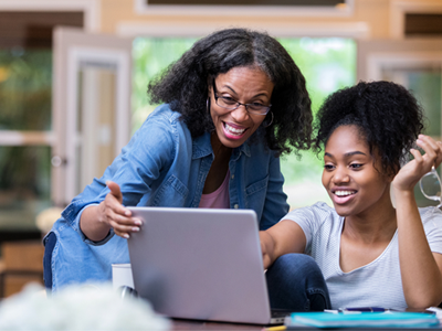 Parent and student looking at laptop computer 